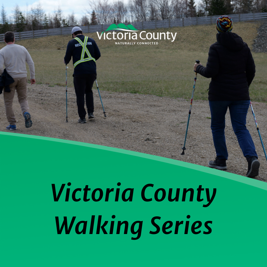 People with walking poles on multi-use trail in Victoria County during a guided walk.