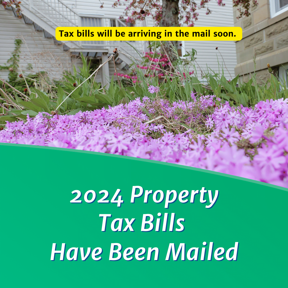 Photo of flowers with text "2024 Property Tax Bills Have Been Mailed"