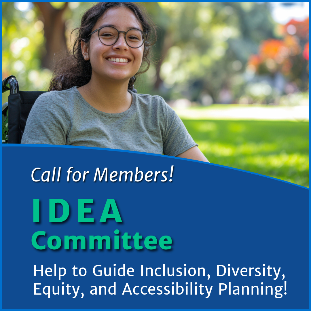 Smiling young woman with glasses and curly brown hair sits in a wheelchair in a sunlit park. She wears a gray t-shirt and looks directly at the camera. The image includes a blue graphic overlay with white and green text that reads: 'Call for Members! IDEA Committee. Help Guide Inclusion, Diversity, Equity, and Accessibility Planning!